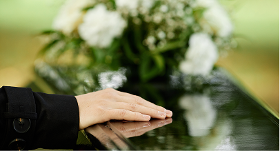 hand on a coffin