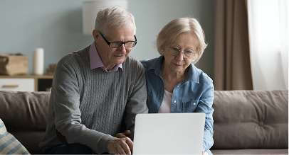 a man and a woman looking at a laptop