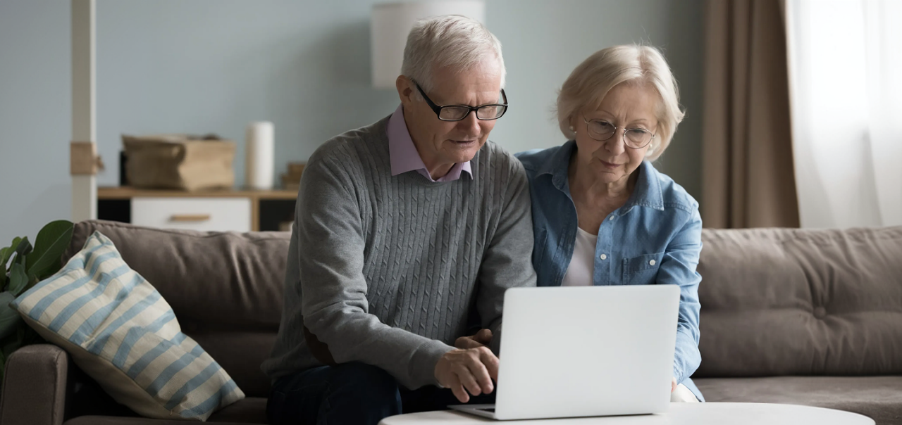 A man and a woman looking at a laptop