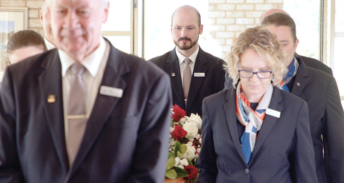 Narooma District funeral directors carrying a coffin into the chapel