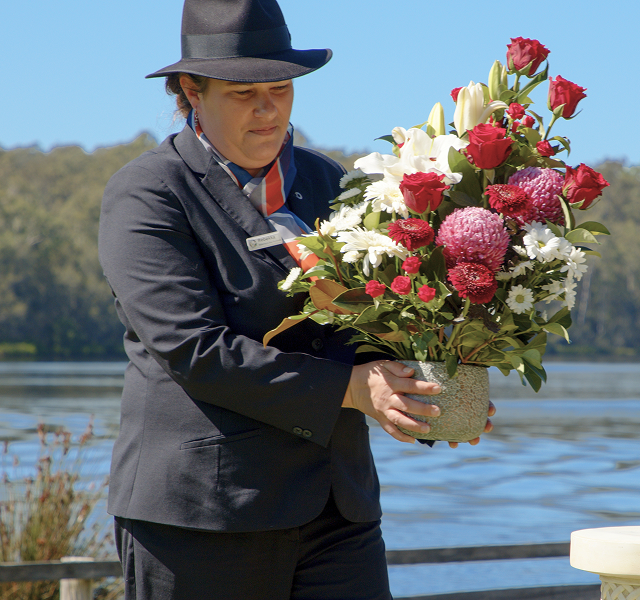 Narooma District funeral director laying a flower