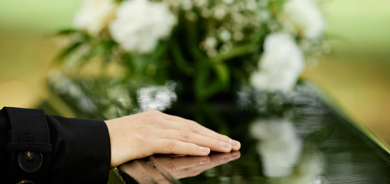 hand on coffin