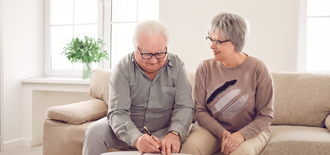  a man and woman signing a document