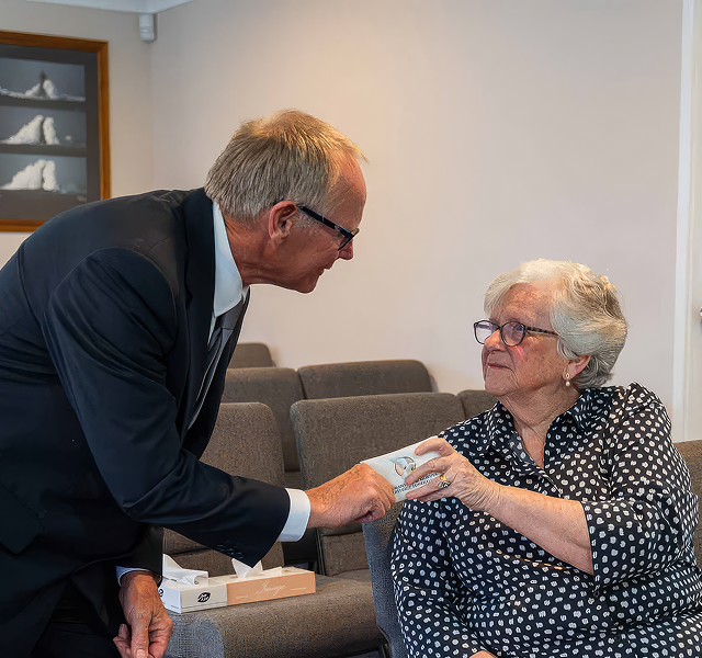 funeral director helping a woman